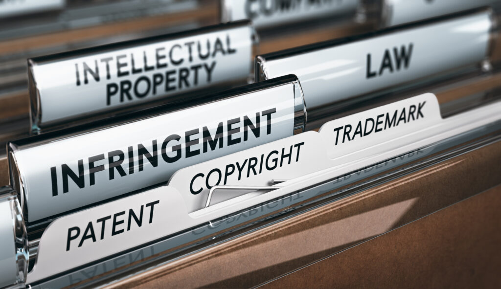 Close-up of filing cabinet tabs labeled Intellectual Property, Law, Infringement, Copyright, and Patent.
